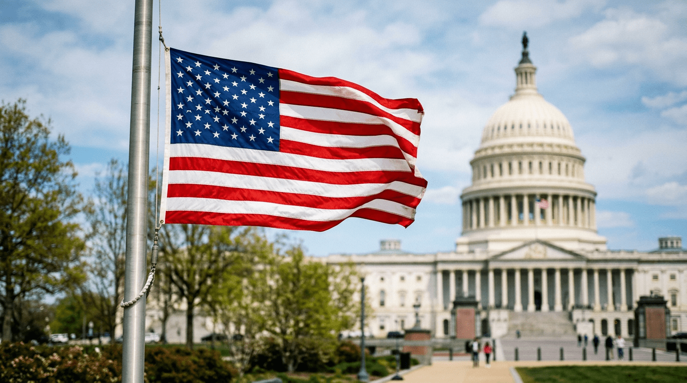 American flag waving on a flagpole with the U.S. Capitol building in the background